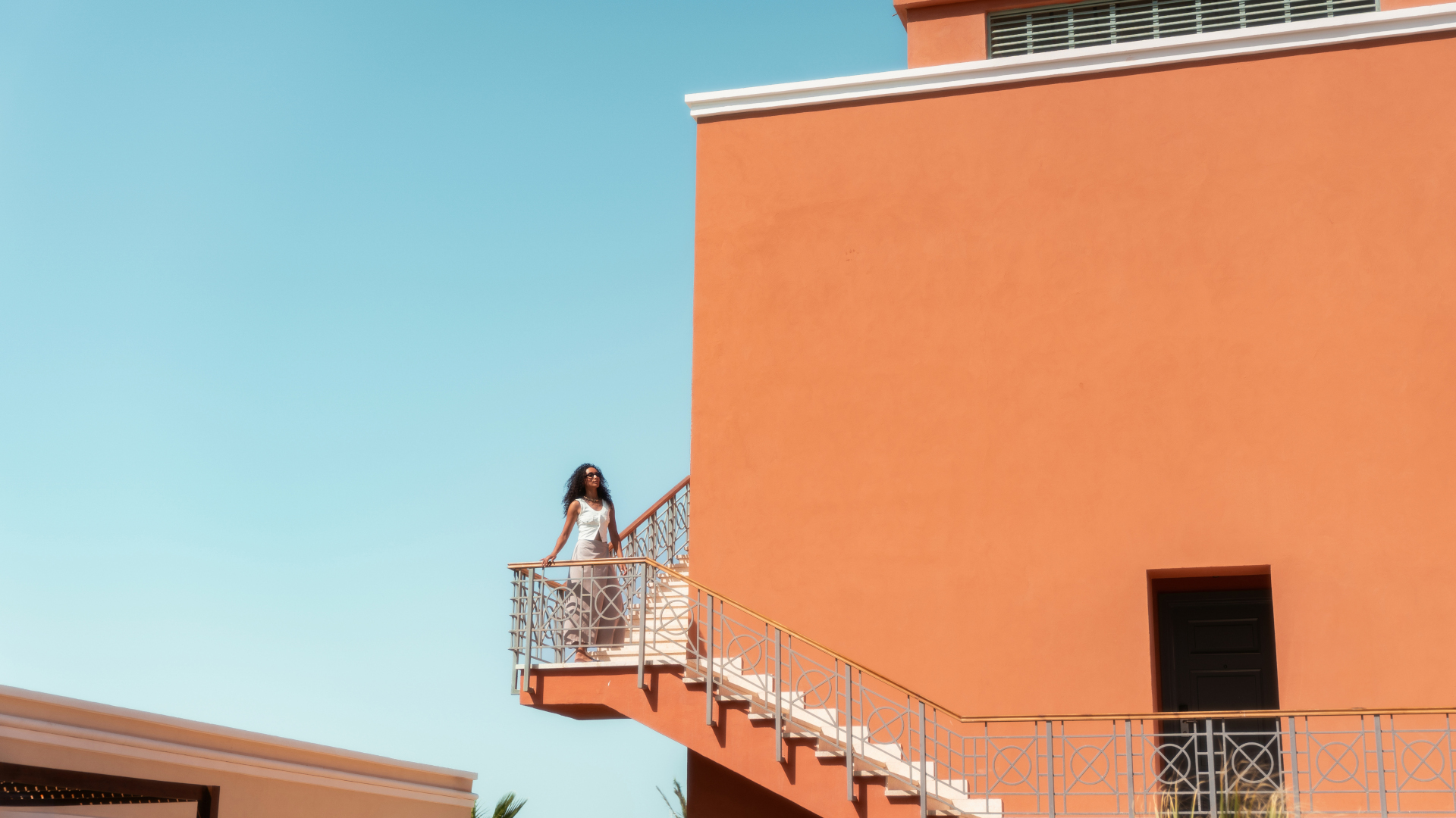 A Person Standing On A Balcony